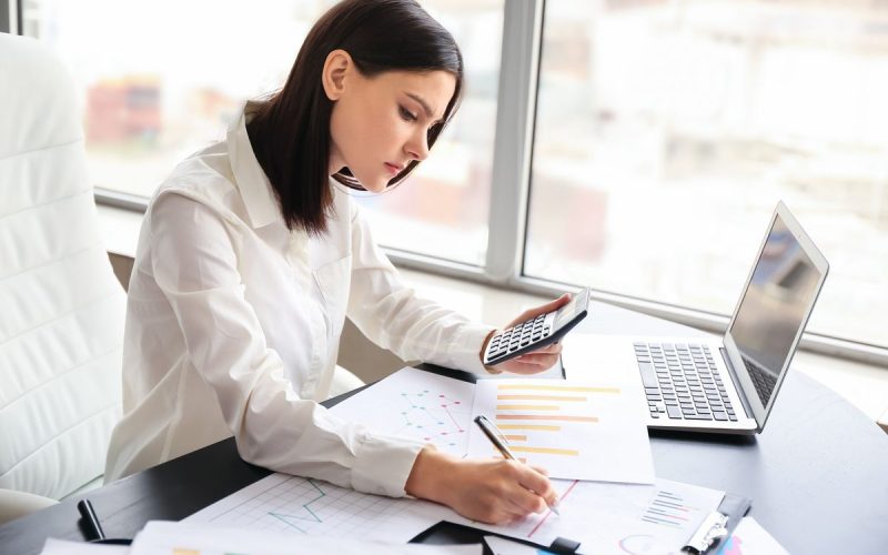 Young female accountant working in office